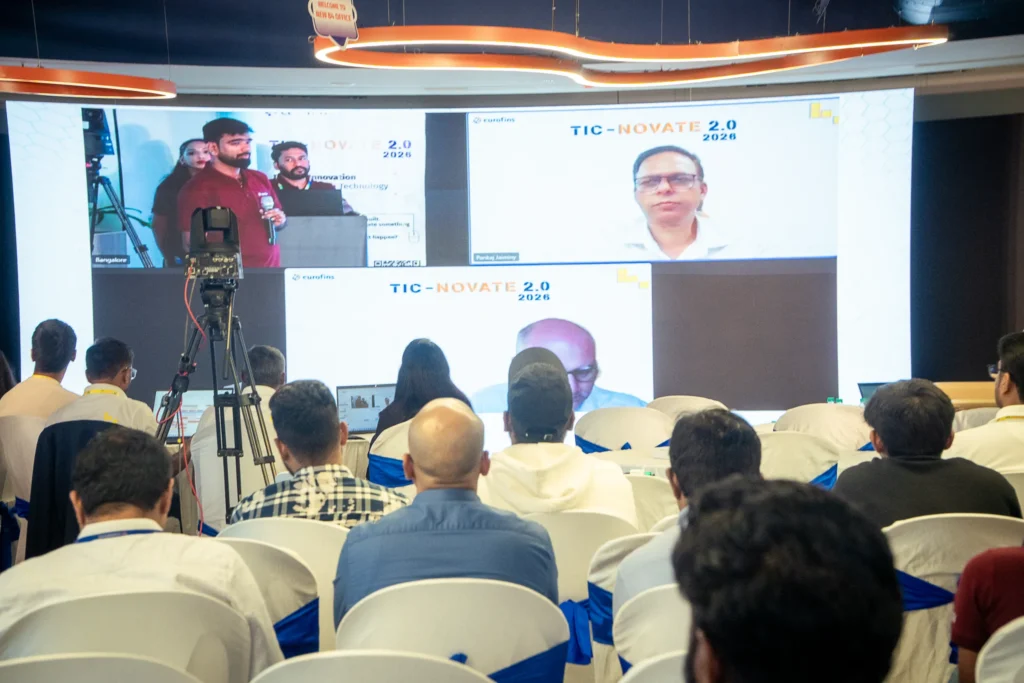 Speaker presenting on stage during a corporate conference in Bangalore.
