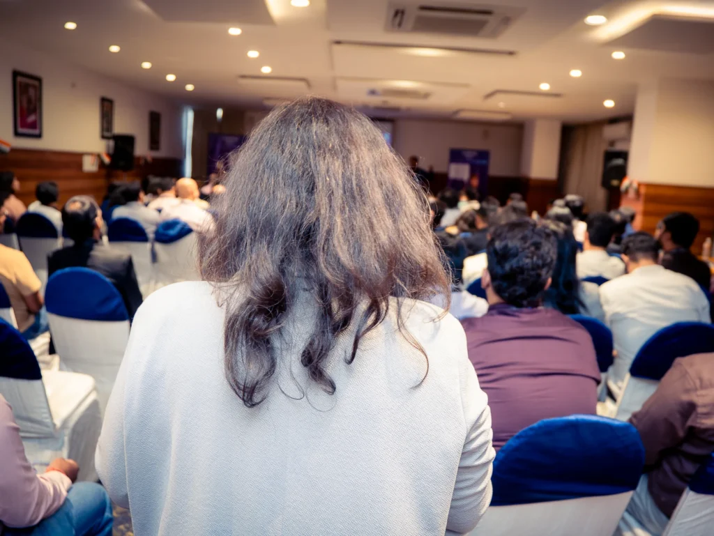 Speaker interacting with attendees during a business conference in Bengaluru.